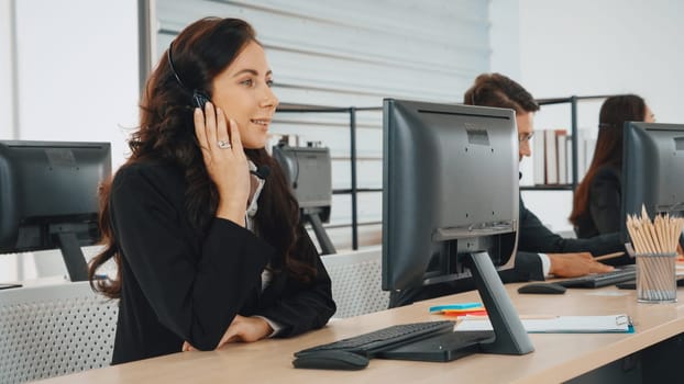 Business people wearing headset working in office to support remote customer or colleague. Call center, telemarketing, customer support agent provide service on telephone video conference call. Jivy