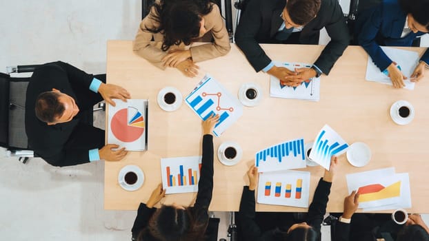 Business people group meeting shot from top view in office . Profession businesswomen, businessmen and office workers working in team conference with project planning document on meeting table . Jivy