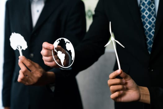Group of business people holding alternative net zero energy icon for greener sustainable Earth with renewable energy technology to reduce CO2 emission. Quaint
