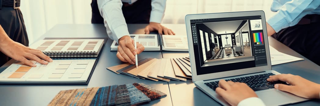 Group of interior architect designer team at table choosing various mood board samples with architecture software on laptop screen. Modern renovation and interior material selection concept. Insight