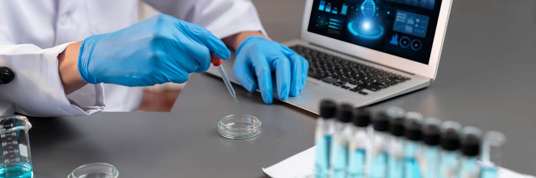 Scientist conduct chemical experiment in medical laboratory, carefully drop precise amount of liquid from pipette into test tube for vaccine drug or antibiotic development. Neoteric