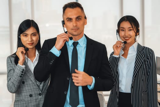 Business people wearing headset working in office to support remote customer or colleague. Call center, telemarketing, customer support agent provide service on telephone video conference call. Jivy