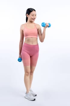 Vigorous energetic woman doing dumbbell weight lifting exercise on isolated background. Young athletic asian woman strength and endurance training session as body workout routine.