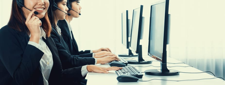 Business people wearing headset working in office to support remote customer or colleague. Call center, telemarketing, customer support agent provide service on telephone video conference oratory call