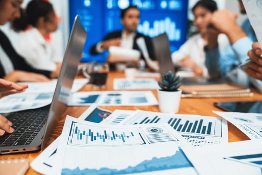 Piles of analyzed financial data dashboard on meeting table with background of business people analyzing data analysis market trend indication for strategic marketing investment plan. Habiliment