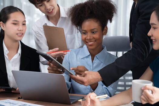 Happy diverse business people work together, discussing in corporate office. Professional and diversity teamwork discuss business plan on desk with laptop. Modern multicultural office worker. Concord