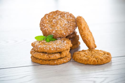 cooked sweet oatmeal cookies on a light wooden table