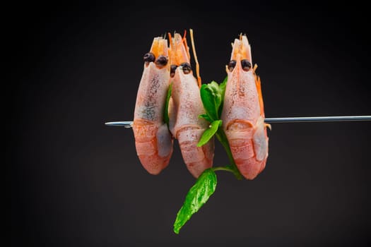 boiled shrimp with spices isolated on black background