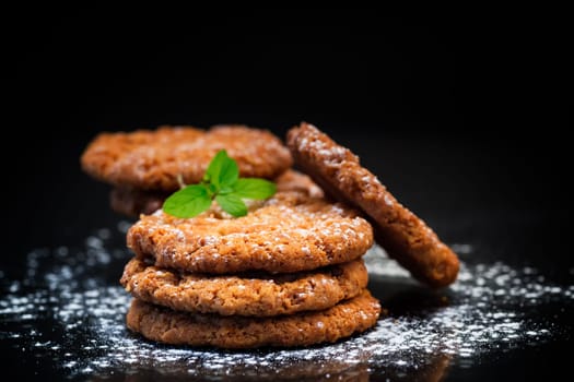 cooked sweet oatmeal cookies, isolated on black background