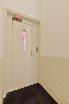 an empty room with white walls and purple carpeting on the floor there is a closed door in the corner