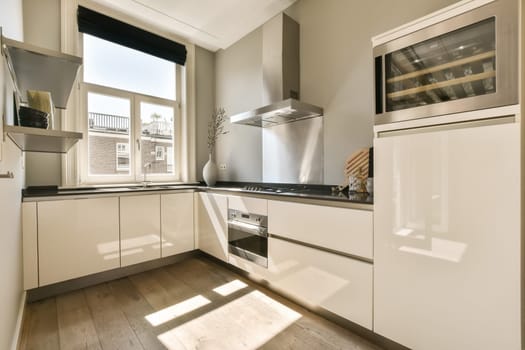 a modern kitchen with white cupboards and stainless steel appliances on the counter tops in this photo is taken from inside