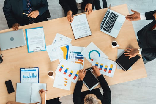 Business people group meeting shot from top view in office . Profession businesswomen, businessmen and office workers working in team conference with project planning document on meeting table . Jivy