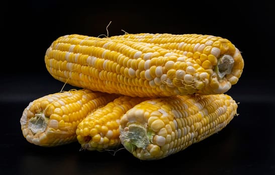 A Table Top View of Corn on the Cob, Whit a Black Background, Sitting on the Table