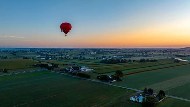 An Aerial View of a Red Hot Air Balloon, Floating Across Rural Pennsylvania, on a Sunny Morning, in the Summer