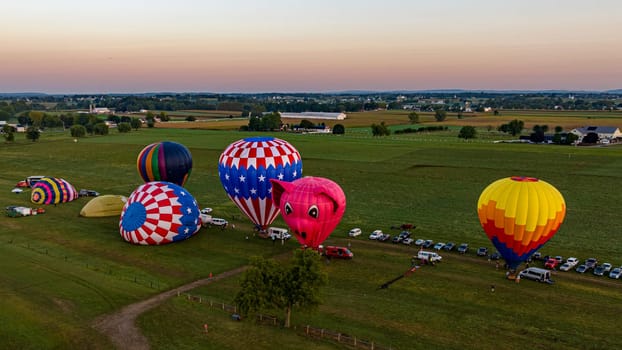 Bird in Hand, Pennsylvania, September 14, 2023 - An Aerial View of a Line of Hot Air Balloons Getting Ready for an Early Morning Launch, on a Summer Day