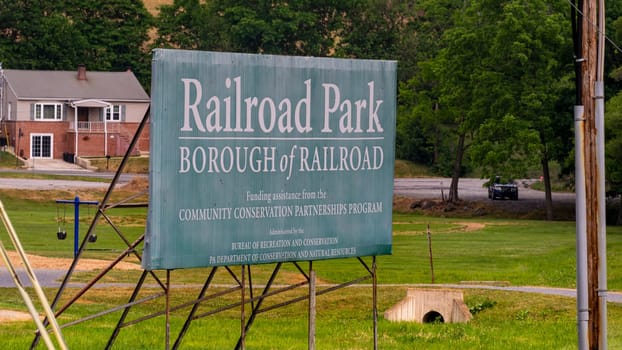 Railroad, Pennsylvania, June 17, 2023 - A View of Railroad Park Sign as Seen by a Train on a Spring Day