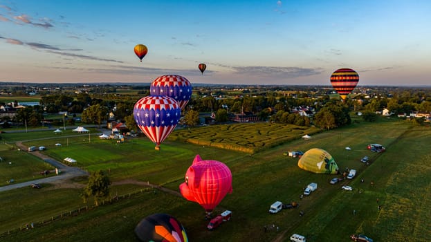 Bird in Hand, Pennsylvania, September 14, 2023 - An Aerial View of Multiple Hot Air Balloons Floating Up During a Morning Launch on a Sunny Summer Day