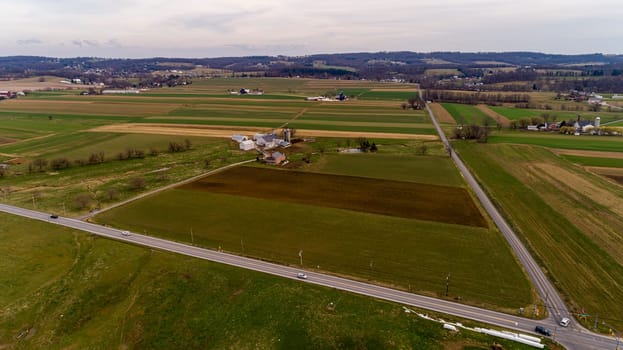 A Drone Landscape of Amish Countryside With Farmland, Farms and Rolling Hills on a Winter Day