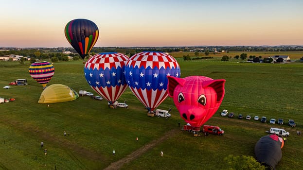 Bird in Hand, Pennsylvania, September 14, 2023 - An Aerial View of a Line of Hot Air Balloons Getting Ready for an Early Morning Launch, on a Summer Day