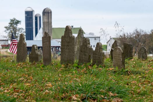 View of an Old Cemetery, with Very Old Headstones, in the Middle of the Countryside, Near a Farm, on a Fall Day