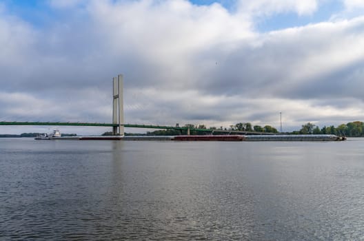 Aerial panorama of a large barge under the Great River Bridge across Mississippi between Burlington Iowa and Illinois