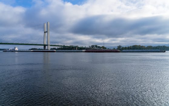 Aerial panorama of a large barge under the Great River Bridge across Mississippi between Burlington Iowa and Illinois