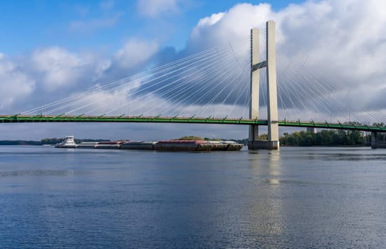 Aerial panorama of a large barge under the Great River Bridge across Mississippi between Burlington Iowa and Illinois