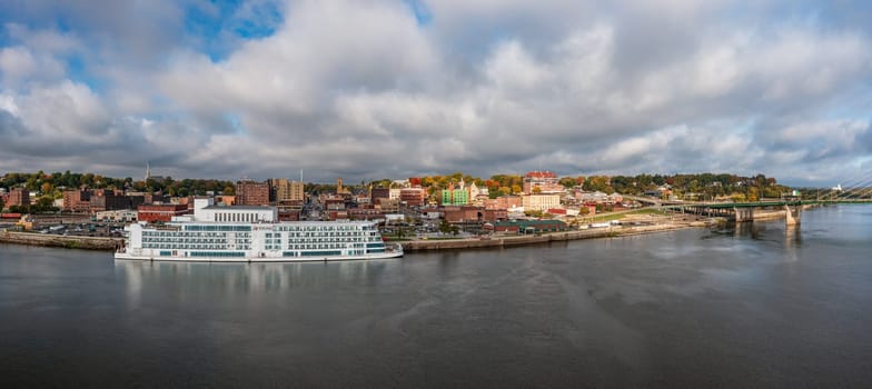 Burlington, IA - 19 October 2023: Aerial panorama of the city skyline with the Viking Mississippi docked on the waterfront in Iowa