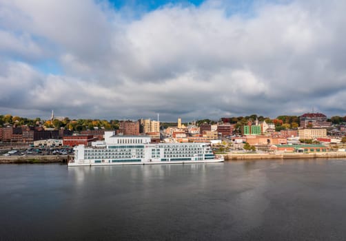 Burlington, IA - 19 October 2023: Aerial panorama of the city skyline with the Viking Mississippi docked on the waterfront in Iowa