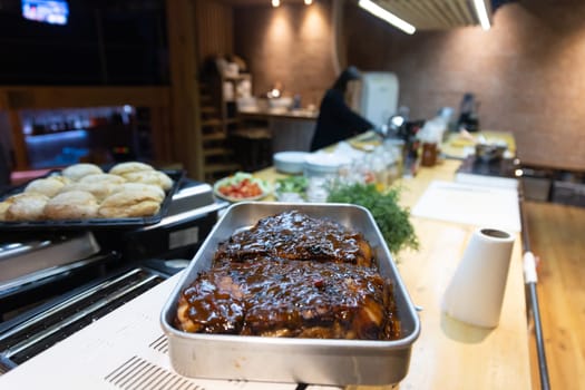 Fried meat - pork - dishes spread on a wooden table, revealing culinary diversity.