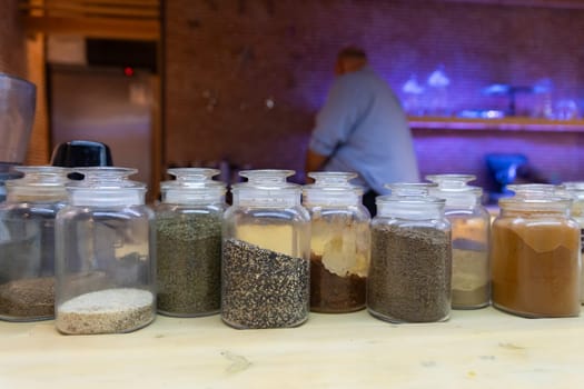 A chef is skillfully preparing dishes behind a counter, showcasing culinary expertise.