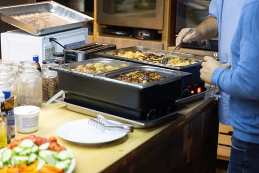 A chef is deeply focused on cooking at a stove, emphasizing the intensity of the culinary process.