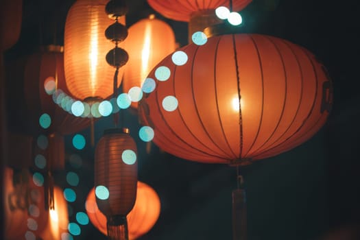 AOrange china lanterns hanging among others, casting a warm and inviting glow.