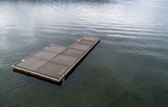 platform used for swimming in an empty lake during a cold day