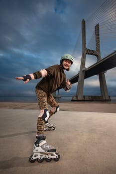 Roller skating girl in park rollerblading on inline skates. Caucasian young woman in outdoor activities