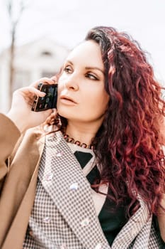 brunette businesswoman talking mobile phone with client. Woman managing business talking via mobile phone sitting.