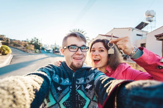 Happy Couple showing their new house keys.