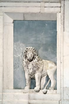 Italy. Venice. Streets and ancient buildings of Venice. There is a picture of a lion on the wall of the small church.