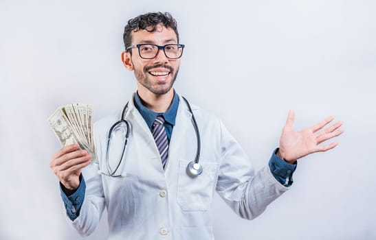 Handsome doctor showing money on white background. Cheerful doctor showing dollars isolated