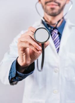 Unrecognizable doctor holding a stethoscope on white background. Close up of doctor holding stethoscope isolated