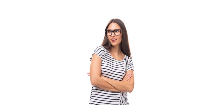 portrait of a young cute casual european woman with long dark hair dressed in a striped t-shirt on a white background with copy space.