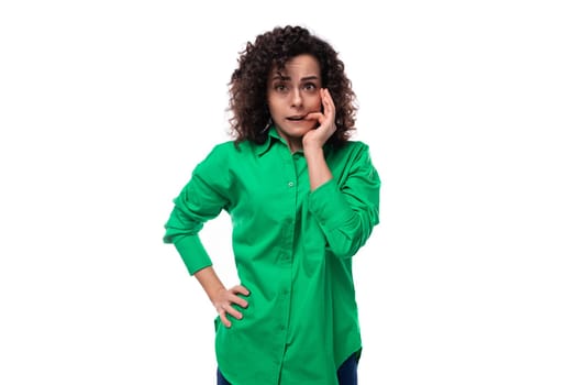 pretty young business woman dressed in a green shirt is brainstorming.