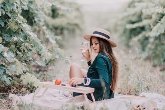 Picnic and wine tasting at sunset in the hills of Italy, Tuscany. Vineyards and open nature in the summer. Romantic dinner, fruit and wine.