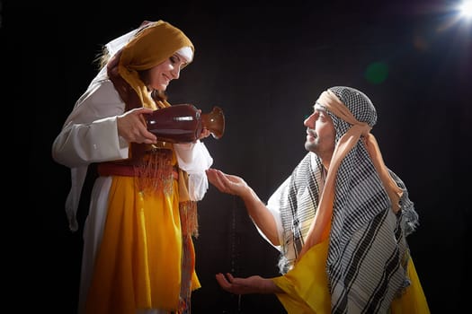 A couple in love or a married couple in stylized Eastern clothing from Israel, Palestine, Iran, Pakistan together. Tender photo session in the style of the Middle East and the Bible