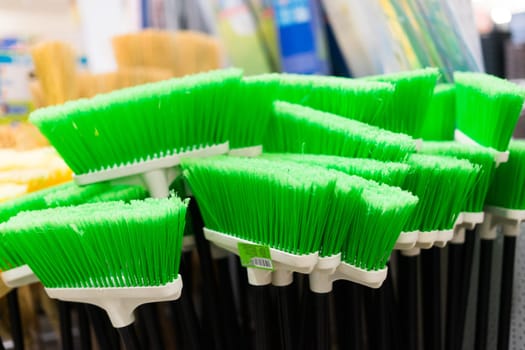 Large assortment of brushes for cleaning premises in store. Trade in floor cleaning equipment