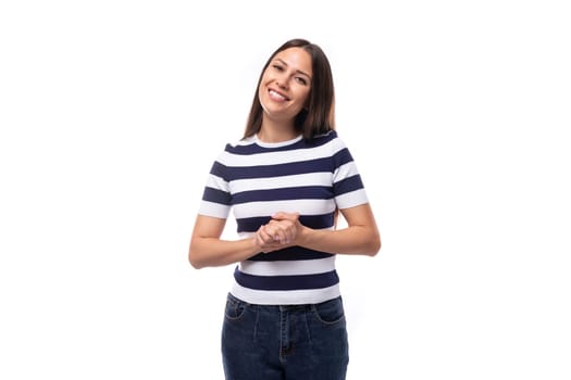 joyful young european promoter woman with black straight hair in a striped black and white t-shirt and jeans.