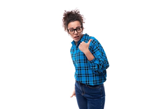 a young brunette woman with glasses is dressed in a loose-fitting blue plaid shirt.