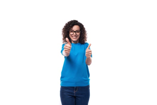 young happy woman dressed in a blue t-shirt made curly hair styling.