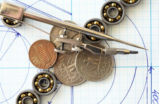 Business concept. Set of ball bearings  with coins on diagram background