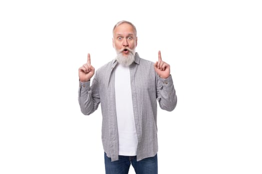 well-groomed gray-haired senior man with a beard and mustache in a shirt is confident.